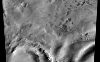 <h1>PIA04910:  Mars South Polar Layered Deposits</h1><div class="PIA04910" lang="en" style="width:512px;text-align:left;margin:auto;background-color:#000;padding:10px;max-height:150px;overflow:auto;">December 8, 2003<p />Remarkable layered deposits covering older, cratered surfaces near Mars' south pole dominate this mosaic of images taken by the camera on NASA's Mars Odyssey spacecraft between Nov. 8 and Nov. 26, 2003. The margin of these layered deposits appears to be eroding poleward, exposing a series of layers in the retreating cliff.<p />The mosaic, stitched from eight visible-wavelength images from Odyssey's thermal emission imaging system, covers an area more than 325 kilometers (200 miles) long and 100 kilometers (62 miles) wide. The pictured area lies between 78 degrees and 82 degrees south latitude and between 90 degrees and 104 degrees east longitude.<p /><a href="/figures/PIA04910_context1.jpg"></a> Click on image for larger view <br><p />A zoom shows details in an area about 75 kilometers (47 miles) by 100 kilometers (62 miles), centered at about 80 degrees south latitude and 99 degrees east longitude. An older impact crater in the left part of the scene is filled with younger deposits from the layered terrain.<p /><a href="/figures/PIA04910_context2.jpg"></a> Click on image for larger view <br><p />A further zoom emphasizes a small, fresh crater about 350 meters (1,150 feet) in diameter near the center of the scene. The adjacent cliff contains numerous individual layers. An unusual set of small mesas, seen in the lower right part of the image, is being eroded from the polar layered material. The images making up this mosaic have a spatial resolution of 36 meters (118 feet) per pixel, allowing detection of features as small as 75 to 100 meters (246 to 328 feet) across.<p />NASA's Jet Propulsion Laboratory manages the 2001 Mars Odyssey mission for the NASA Office of Space Science, Washington. The thermal emission imaging system on Odyssey was developed by Arizona State University, Tempe, in collaboration with Raytheon Santa Barbara Remote Sensing. Lockheed Martin Space Systems, Denver, is the prime contractor for the Odyssey project, and developed and built the orbiter. Mission operations are conducted jointly from Lockheed Martin and from JPL, a division of the California Institute of Technology in Pasadena.<br /><br /><a href="http://photojournal.jpl.nasa.gov/catalog/PIA04910" onclick="window.open(this.href); return false;" title="Voir l'image 	 PIA04910:  Mars South Polar Layered Deposits	  sur le site de la NASA">Voir l'image 	 PIA04910:  Mars South Polar Layered Deposits	  sur le site de la NASA.</a></div>