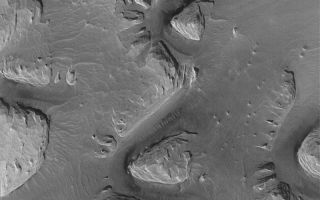 <h1>PIA04919:  Wind-Eroded Terrain near Olympus Mons</h1><div class="PIA04919" lang="en" style="width:800px;text-align:left;margin:auto;background-color:#000;padding:10px;max-height:150px;overflow:auto;">MGS MOC Release No. MOC2-569, 9 December 2003<p />This Mars Global Surveyor (MGS) Mars Orbiter Camera (MOC) image shows wind-eroded material, possibly sedimentary rock, among the ridges of the Lycus Sulci region west of Olympus Mons. The darker surfaces and the dark-toned ripples on those surfaces indicate there may be windblown sand present in these areas. This October 2003 picture is located near 17.8°N, 143.7°W. The image covers an area approximately 3 km (1.9 mi) wide and is illuminated from the lower left.<br /><br /><a href="http://photojournal.jpl.nasa.gov/catalog/PIA04919" onclick="window.open(this.href); return false;" title="Voir l'image 	 PIA04919:  Wind-Eroded Terrain near Olympus Mons	  sur le site de la NASA">Voir l'image 	 PIA04919:  Wind-Eroded Terrain near Olympus Mons	  sur le site de la NASA.</a></div>