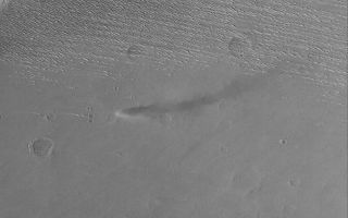 <h1>PIA04973:  Daedalia Dust Devil</h1><div class="PIA04973" lang="en" style="width:800px;text-align:left;margin:auto;background-color:#000;padding:10px;max-height:150px;overflow:auto;">MGS MOC Release No. MOC2-574, 14 December 2003<p />This Mars Global Surveyor (MGS) Mars Orbiter Camera (MOC) image shows an active dust devil making its way across an intercrater surface in western Daedalia Planum. This picture, a MOC "classic," was obtained back in October 1999. Sunlight illuminates the scene [missing text] curved shadow cast by the spinning column of air can be seen to the right of the dust devil. This area is located near 10.0°S, 143.0°W. The image covers an area 3 km (1.9 mi) wide.<br /><br /><a href="http://photojournal.jpl.nasa.gov/catalog/PIA04973" onclick="window.open(this.href); return false;" title="Voir l'image 	 PIA04973:  Daedalia Dust Devil	  sur le site de la NASA">Voir l'image 	 PIA04973:  Daedalia Dust Devil	  sur le site de la NASA.</a></div>