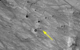 <h1>PIA04987:  Approximate Location of Spirit</h1><div class="PIA04987" lang="en" style="width:601px;text-align:left;margin:auto;background-color:#000;padding:10px;max-height:150px;overflow:auto;">This image, taken previously by the Mars Orbiter Camera onboard Mars Global Surveyor, highlights the same cluster of craters captured by the Mars Exploration Rover Spirit as it descends to Mars.<br /><br /><a href="http://photojournal.jpl.nasa.gov/catalog/PIA04987" onclick="window.open(this.href); return false;" title="Voir l'image 	 PIA04987:  Approximate Location of Spirit	  sur le site de la NASA">Voir l'image 	 PIA04987:  Approximate Location of Spirit	  sur le site de la NASA.</a></div>
