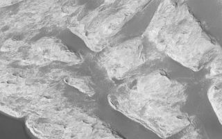 <h1>PIA05118:  "White Rock" of Pollack Crater</h1><div class="PIA05118" lang="en" style="width:800px;text-align:left;margin:auto;background-color:#000;padding:10px;max-height:150px;overflow:auto;">1 January 2004 <br /> The famous "White Rock" of Pollack Crater has been known for three decades; it was originally found in images acquired by the Mariner 9 spacecraft in 1972. This Mars Global Surveyor (MGS) Mars Orbiter Camera (MOC) close-up view, obtained in October 2003, shows some of the light-toned, wind-eroded sedimentary rock that makes up "White Rock." It is not actually white, except when viewed in a processed, grayscale image (in color, it is more of a light butterscotch to pinkish material). The sediment that comprises "White Rock" was deposited in Pollack Crater a long time ago, perhaps billions of years ago; the material was later eroded by wind. Dark, windblown ripples are present throughout the scene. This picture is located near 8.2°S, 335.1°W, and covers an area about 3 km (1.9 mi) wide. Sunlight illuminates the scene from the lower left.<br /><br /><a href="http://photojournal.jpl.nasa.gov/catalog/PIA05118" onclick="window.open(this.href); return false;" title="Voir l'image 	 PIA05118:  "White Rock" of Pollack Crater	  sur le site de la NASA">Voir l'image 	 PIA05118:  "White Rock" of Pollack Crater	  sur le site de la NASA.</a></div>