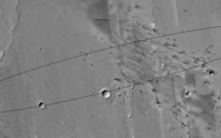 <h1>PIA05120:  Mars Exploration Rover (MER-A) Spirit Landing Site</h1><div class="PIA05120" lang="en" style="width:800px;text-align:left;margin:auto;background-color:#000;padding:10px;max-height:150px;overflow:auto;"><p>3 January 2004 <br />Excitement builds as the first Mars Exploration Rover (MER-A), Spirit, prepares to land on Mars just after 8:35 p.m. Pacific Standard Time today, 3 January 2004 (04:35, 4 January 2004 UTC). Today's Mars Global Surveyor (MGS) Mars Orbiter Camera (MOC) picture is a mosaic of MOC images of the Spirit landing site. The rover is expected to land somewhere within the approximately 83 km (~52 mi) long by ~10 km (~6 mi) wide ellipse on the floor of <a href="/catalog/PIA05119">Gusev Crater</a>. Clicking on the image above will show a map of the landing site at 25 meters (82 feet) per pixel. MOC has acquired 71 pictures of the landing site over a period spanning 3 Mars years (from July 1999 through December 2003), and more than 85 pictures were acquired within Gusev Crater specifically to support the Mars Exploration Rover landing site selection process. These pictures were acquired not only in different years, but in different seasons, so the illumination angle, overall brightness, and patterns of ephemeral, dark dust devil streaks and wind streaks are different from image to image within the mosaic. In areas where no MOC coverage exists, gaps were filled using images from the Mars Odyssey Thermal Emission Imaging System (THEMIS) visible imager, a lower-resolution camera built by Malin Space Science Systems and operated by Arizona State University. The Gusev Crater landing ellipse is centered near 14.8°S, 184.8°W. Sunlight illuminates each image in the mosaic from the left (in some cases, upper left, in others, lower left).<p />Spirit will land at about 2 p.m. local time on Mars. At the same time, Mars Global Surveyor will pass over the site and listen for a transmission of Spirit's entry, descent, and landing data. These data will be relayed back to Earth by the MOC. For more information about the Mars Exploration Rovers, visit <a href="http://marsweb.jpl.nasa.gov/">NASA/JPL's Mars Exploration Program Web site</a>. For more information about the work that Malin Space Science Systems and MGS MOC are doing in support of the rover missions, see: <a href="http://www.msss.com/mer_mission/">http://www.msss.com/mer_mission/</a>. For information about how MSSS will use this mosaic of the landing site to help find Spirit after it touches down, see <a href="http://www.msss.com/mer_mission/finding_mer/">Finding MERs</a>.<br /><br /><a href="http://photojournal.jpl.nasa.gov/catalog/PIA05120" onclick="window.open(this.href); return false;" title="Voir l'image 	 PIA05120:  Mars Exploration Rover (MER-A) Spirit Landing Site	  sur le site de la NASA">Voir l'image 	 PIA05120:  Mars Exploration Rover (MER-A) Spirit Landing Site	  sur le site de la NASA.</a></div>
