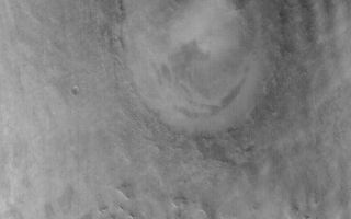 <h1>PIA05244:  Lyot Crater in Winter</h1><div class="PIA05244" lang="en" style="width:512px;text-align:left;margin:auto;background-color:#000;padding:10px;max-height:150px;overflow:auto;">19 January 2004 <br /> This somewhat oblique Mars Global Surveyor (MGS) Mars Orbiter Camera (MOC) red wide angle view of Lyot Crater and the mesas of the Deuteronilus Mensae was acquired in January 2004 on the day after the Mars Exploration Rover, Spirit, landed in Gusev Crater on the other side of the planet. It is winter in the northern hemisphere of Mars, and winter for Lyot Crater means clouds. The brighter features in the atmosphere above the surface in this image are clouds. Lyot Crater is about 236 km (~147 mi.) in diameter. The center of this image is near 48.5°N, 331.0°W, and is illuminated from the lower left.<br /><br /><a href="http://photojournal.jpl.nasa.gov/catalog/PIA05244" onclick="window.open(this.href); return false;" title="Voir l'image 	 PIA05244:  Lyot Crater in Winter	  sur le site de la NASA">Voir l'image 	 PIA05244:  Lyot Crater in Winter	  sur le site de la NASA.</a></div>