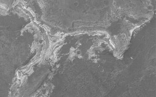<h1>PIA05252:  Sedimentary Rocks in Ladon Vallis</h1><div class="PIA05252" lang="en" style="width:800px;text-align:left;margin:auto;background-color:#000;padding:10px;max-height:150px;overflow:auto;">25 January 2004 <br /> This is a Mars Global Surveyor (MGS) Mars Orbiter Camera (MOC) picture of an outcrop of light-toned, layered, sedimentary rock exposed by erosion in Ladon Vallis. These rocks preserve clues to the martian past. However, like books in a library, one needs to go there and check them out if one wishes to read what the layers have to say. This November 2003 picture is located near 21.1°S, 29.8°W, and covers an area 3km (1.9 mi.) wide. Sunlight illuminates the scene from the left.<br /><br /><a href="http://photojournal.jpl.nasa.gov/catalog/PIA05252" onclick="window.open(this.href); return false;" title="Voir l'image 	 PIA05252:  Sedimentary Rocks in Ladon Vallis	  sur le site de la NASA">Voir l'image 	 PIA05252:  Sedimentary Rocks in Ladon Vallis	  sur le site de la NASA.</a></div>