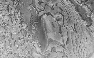 <h1>PIA05254:  Sedimentary Rock Layers</h1><div class="PIA05254" lang="en" style="width:640px;text-align:left;margin:auto;background-color:#000;padding:10px;max-height:150px;overflow:auto;">27 January 2004 <br /> This Mars Global Surveyor (MGS) Mars Orbiter Camera (MOC) image shows layers of sedimentary rock in a crater in western Arabia Terra. Layered rock records the history of a place, but an orbiter image alone cannot tell the entire story. These materials record some past episodes of deposition of fine-grained material in an impact crater that is much larger than the image shown here. The picture is located near 3.4°N, 358.7°W, and covers an area 3 km (1.9 mi.) wide. Sunlight illuminates the scene from the lower left.<br /><br /><a href="http://photojournal.jpl.nasa.gov/catalog/PIA05254" onclick="window.open(this.href); return false;" title="Voir l'image 	 PIA05254:  Sedimentary Rock Layers	  sur le site de la NASA">Voir l'image 	 PIA05254:  Sedimentary Rock Layers	  sur le site de la NASA.</a></div>