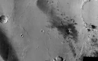 <h1>PIA05335:  Gusev Crater, here we come!</h1><div class="PIA05335" lang="en" style="width:800px;text-align:left;margin:auto;background-color:#000;padding:10px;max-height:150px;overflow:auto;"><a href="/figures/PIA05335_context.jpg"></a><br /><p />Released 3 January 2004<p />This evening at approximately 8:35 PST the Mars Exploration Rover named <a href="http://marsrovers.jpl.nasa.gov/">Spirit</a> will bounce to the ground somewhere in this scene. The image is composed of nine THEMIS VIS frames that have been mosaiced together, producing a complete picture of the region in which the rover is predicted to land. <p > The dark streaks are places where wind has either scoured off the brighter martian dust or has covered it up by sand. Note the interesting lobes of material evident along the right side of the image just below the large crater. These may be due to the emplacement of water rich sediments or possibly lava flows. It is hoped that Spirit and all of its instruments will help us to understand the rich geologic history that is on display in this image. The biggest question to be answered: was Gusev Crater filled with water sometime in its ancient past? Stay tuned...<p />Mosaic produced by Noel Gorelick, ASU/THEMIS Team.<p />Image information: VIS instrument. Latitude -14.8, Longitude 175.2 East (184.8 West). 19 meter/pixel resolution.<p />Note: this THEMIS visual image has not been radiometrically nor geometrically calibrated for this preliminary release. An empirical correction has been performed to remove instrumental effects. A linear shift has been applied in the cross-track and down-track direction to approximate spacecraft and planetary motion. Fully calibrated and geometrically projected images will be released through the Planetary Data System in accordance with Project policies at a later time.<p />NASA's Jet Propulsion Laboratory manages the 2001 Mars Odyssey mission for NASA's Office of Space Science, Washington, D.C. The Thermal Emission Imaging System (THEMIS) was developed by Arizona State University, Tempe, in collaboration with Raytheon Santa Barbara Remote Sensing. The THEMIS investigation is led by Dr. Philip Christensen at Arizona State University. Lockheed Martin Astronautics, Denver, is the prime contractor for the Odyssey project, and developed and built the orbiter. Mission operations are conducted jointly from Lockheed Martin and from JPL, a division of the California Institute of Technology in Pasadena.<br /><br /><a href="http://photojournal.jpl.nasa.gov/catalog/PIA05335" onclick="window.open(this.href); return false;" title="Voir l'image 	 PIA05335:  Gusev Crater, here we come!	  sur le site de la NASA">Voir l'image 	 PIA05335:  Gusev Crater, here we come!	  sur le site de la NASA.</a></div>