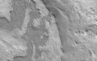 <h1>PIA05532:  East Arabia Layers</h1><div class="PIA05532" lang="en" style="width:800px;text-align:left;margin:auto;background-color:#000;padding:10px;max-height:150px;overflow:auto;">6 March 2004 <br />This Mars Global Surveyor (MGS) Mars Orbiter Camera (MOC) image shows eroded layered material in eastern Arabia Terra. The darkest material in this image forms a couple of mesas of ancient layered rock. Eastern Arabia is one of several regions on Mars that have been eroded in such a way as to provide clues about the nature of the layered upper crust of Mars. The image is located near 25.0°N, 302.4°W, and covers an area 3 km (1.9 mi) wide. Sunlight illuminates the scene from the lower left.<br /><br /><a href="http://photojournal.jpl.nasa.gov/catalog/PIA05532" onclick="window.open(this.href); return false;" title="Voir l'image 	 PIA05532:  East Arabia Layers	  sur le site de la NASA">Voir l'image 	 PIA05532:  East Arabia Layers	  sur le site de la NASA.</a></div>