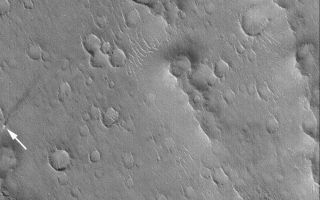 <h1>PIA05536:  Isidis Dust Devil</h1><div class="PIA05536" lang="en" style="width:601px;text-align:left;margin:auto;background-color:#000;padding:10px;max-height:150px;overflow:auto;">10 March 2004 <br />This arrow in this Mars Global Surveyor (MGS) Mars Orbiter Camera (MOC) image points to an active dust devil observed in Isidis Planitia near 18.3°N, 268.9°W. The columnar shadow of the dust devil is visible, as is a pencil-thin (at least, pencil-thin at the scale of the image) line created by the vortex as it disrupted the dust that coats the surface. The streak indicates that the dust devil had already traveled more than 3 kilometers (1.9 miles), over craters, large ripples, and ridges, before the MOC took this picture. The dust devil was moving from the northeast (upper right) toward the southwest (lower left). Sunlight illuminates the scene from the lower left; the image covers an area 3 km (1.9 mi) wide.<br /><br /><a href="http://photojournal.jpl.nasa.gov/catalog/PIA05536" onclick="window.open(this.href); return false;" title="Voir l'image 	 PIA05536:  Isidis Dust Devil	  sur le site de la NASA">Voir l'image 	 PIA05536:  Isidis Dust Devil	  sur le site de la NASA.</a></div>
