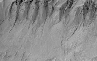 <h1>PIA05695:  Gullied Slope</h1><div class="PIA05695" lang="en" style="width:800px;text-align:left;margin:auto;background-color:#000;padding:10px;max-height:150px;overflow:auto;">20 March 2004<br />This Mars Global Surveyor (MGS) Mars Orbiter Camera (MOC) image shows gullies and debris aprons in a crater near 38.5°S, 174.5°W. Gullies such as these may have formed by running water, carbon dioxide, or dry mass movement processes. Most investigators of martian gullies consider that water, whether fresh or briney, may have been involved. This picture covers an area about 3 km (1.9 mi) across. Sunlight illuminates the scene from the upper left.<br /><br /><a href="http://photojournal.jpl.nasa.gov/catalog/PIA05695" onclick="window.open(this.href); return false;" title="Voir l'image 	 PIA05695:  Gullied Slope	  sur le site de la NASA">Voir l'image 	 PIA05695:  Gullied Slope	  sur le site de la NASA.</a></div>