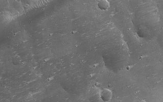<h1>PIA05699:  Craters and Wind Streaks</h1><div class="PIA05699" lang="en" style="width:672px;text-align:left;margin:auto;background-color:#000;padding:10px;max-height:150px;overflow:auto;">25 March 2004<br />This Mars Global Surveyor (MGS) Mars Orbiter Camera (MOC) image shows a plethora of small wind tails or streaks in the lees of impact craters in northeastern Tharsis near 25.8°N, 89.0°W. The streak tails point toward the east/northeast (right), indicating that the dominant winds blow from the west/southwest (left). This February 2004 picture covers an area about 3 km (1.9 mi) across. Sunlight illuminates the scene from the lower left.<br /><br /><a href="http://photojournal.jpl.nasa.gov/catalog/PIA05699" onclick="window.open(this.href); return false;" title="Voir l'image 	 PIA05699:  Craters and Wind Streaks	  sur le site de la NASA">Voir l'image 	 PIA05699:  Craters and Wind Streaks	  sur le site de la NASA.</a></div>