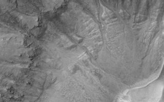 <h1>PIA05707:  Gullies in Crater</h1><div class="PIA05707" lang="en" style="width:800px;text-align:left;margin:auto;background-color:#000;padding:10px;max-height:150px;overflow:auto;">2 April 2004<br />This Mars Global Surveyor (MGS) Mars Orbiter Camera (MOC) image shows gullies in the wall of a large southern mid-latitude impact crater located near 39.8°S, 202.0°W. The gullies might have formed by transport of water and sediment down these crater slopes. Alternatively, a fluid other than water may have been involved (e.g., carbon dioxide), but most investigators agree that water is most likely. The image covers an area about 3 km (1.9 mi) across. Sunlight illuminates the scene from the upper left.<br /><br /><a href="http://photojournal.jpl.nasa.gov/catalog/PIA05707" onclick="window.open(this.href); return false;" title="Voir l'image 	 PIA05707:  Gullies in Crater	  sur le site de la NASA">Voir l'image 	 PIA05707:  Gullies in Crater	  sur le site de la NASA.</a></div>