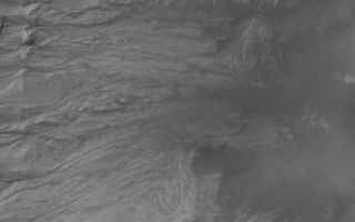 <h1>PIA05711:  Gullies in Crater Wall</h1><div class="PIA05711" lang="en" style="width:297px;text-align:left;margin:auto;background-color:#000;padding:10px;max-height:150px;overflow:auto;">6 April 2004<br />This Mars Global Surveyor (MGS) Mars Orbiter Camera (MOC) image shows gullies in the wall of a large impact crater in Newton Basin near 41.9°S, 158.1°W. Such gullies may have formed by downslope movement of wet debris--i.e., water. Unfortunately, because the responsible fluid (if there was one) is no longer present today, only the geomorphology of the channels and debris aprons can be used to deduce that water might have been involved. The image covers an area about 3 km (1.9 mi) across. Sunlight illuminates the scene from the upper left.<br /><br /><a href="http://photojournal.jpl.nasa.gov/catalog/PIA05711" onclick="window.open(this.href); return false;" title="Voir l'image 	 PIA05711:  Gullies in Crater Wall	  sur le site de la NASA">Voir l'image 	 PIA05711:  Gullies in Crater Wall	  sur le site de la NASA.</a></div>