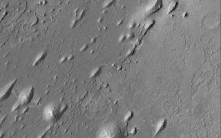 <h1>PIA05947:  West Arabian Yardangs</h1><div class="PIA05947" lang="en" style="width:512px;text-align:left;margin:auto;background-color:#000;padding:10px;max-height:150px;overflow:auto;"><p>17 September 2004<br />The upper crust of Mars consists of layered bedrock. The terrain located between large impact craters is layered. In some regions, some of these layers have been exposed by erosion. This Mars Global Surveyor (MGS) Mars Orbiter Camera (MOC) image shows rounded and streamlined hills produced by wind erosion. In this case, the dominant, erosive winds blew from the upper right (northeast) toward lower left (southwest). The presence of these erosional forms, yardangs, indicates that the material being eroded contains some amount of sand-sized grains that are easily mobilized by wind. These particular yardangs are located in western Arabia Terra, northwest of the Sinus Meridiani region where the Mars Exploration Rover, Opportunity, has examined ancient sedimentary rocks. These landforms are located near 9.4°N, 6.5°W. The image covers an area approximately 3 km (1.9 mi) across and is illuminated by sunlight from the left.</p><br /><br /><a href="http://photojournal.jpl.nasa.gov/catalog/PIA05947" onclick="window.open(this.href); return false;" title="Voir l'image 	 PIA05947:  West Arabian Yardangs	  sur le site de la NASA">Voir l'image 	 PIA05947:  West Arabian Yardangs	  sur le site de la NASA.</a></div>