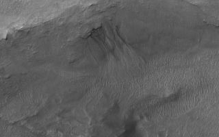 <h1>PIA06303:  Gullied Trough Wall</h1><div class="PIA06303" lang="en" style="width:800px;text-align:left;margin:auto;background-color:#000;padding:10px;max-height:150px;overflow:auto;"><p>13 June 2004<br />This Mars Global Surveyor (MGS) Mars Orbiter Camera (MOC) image shows gullies emergent from beneath erosion-resistant rock layers in a trough south of Atlantis Chaos near 38.9°S, 176.3°W. Gullies such as these are fairly common in depressions at south middle latitudes. Tens of thousands of gullies have been identified in MGS MOC and Mars Odyssey Thermal Emission Imaging System (THEMIS) images. Whether they formed by running liquid water remains a controversial issue. Banked channels, like some shown here, are one form of evidence cited to indicate that a fluid with the properties of liquid water may have been involved. This image covers an area about 3 km (1.9 mi) across. The scene is illuminated by sunlight from the upper left.</p><br /><br /><a href="http://photojournal.jpl.nasa.gov/catalog/PIA06303" onclick="window.open(this.href); return false;" title="Voir l'image 	 PIA06303:  Gullied Trough Wall	  sur le site de la NASA">Voir l'image 	 PIA06303:  Gullied Trough Wall	  sur le site de la NASA.</a></div>