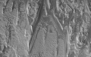 <h1>PIA06323:  Layered Rocks in Crater</h1><div class="PIA06323" lang="en" style="width:800px;text-align:left;margin:auto;background-color:#000;padding:10px;max-height:150px;overflow:auto;"><p>19 June 2004<br />Exposures of layered, sedimentary rock are common on Mars. From the rock outcrops examined by the Mars Exploration Rover, Opportunity, in Meridiani Planum to the sequence in Gale Crater's central mound that is twice the thickness of of the sedimentary rocks exposed by Arizona's Grand Canyon, Mars presents a world of sediment to study. This unusual example, imaged by the Mars Global Surveyor (MGS) Mars Orbiter Camera (MOC), shows eroded layer outcrops in a crater in Terra Tyrrhena near 15.4°S, 270.5°W. Sedimentary rocks provide a record of past climates and events. Perhaps someday the story told by the rocks in this image will be known via careful field work. The image covers an area about 3 km (1.9 mi) wide and is illuminated by sunlight from the left.</p><br /><br /><a href="http://photojournal.jpl.nasa.gov/catalog/PIA06323" onclick="window.open(this.href); return false;" title="Voir l'image 	 PIA06323:  Layered Rocks in Crater	  sur le site de la NASA">Voir l'image 	 PIA06323:  Layered Rocks in Crater	  sur le site de la NASA.</a></div>