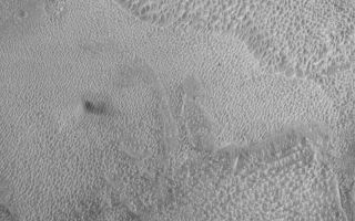 <h1>PIA06327:  Tithonium Dust Devil</h1><div class="PIA06327" lang="en" style="width:800px;text-align:left;margin:auto;background-color:#000;padding:10px;max-height:150px;overflow:auto;"><p>23 June 2004<br />The Mars Global Surveyor (MGS) Mars Orbiter Camera (MOC) captured this chance view of a dust devil (left of the center of the picture) near 2 p.m. local Mars time on 12 April 2004, in western Tithonium Chasma. The dark splotch to the right of the dust devil is its shadow. Sunlight illuminates the scene from the left/upper left. Tithonium is one of the troughs of the Valles Marineris system. The picture is located near 4.7°S, 89.1°W, and covers an area about 3 km (1.9 mi) wide.</p><br /><br /><a href="http://photojournal.jpl.nasa.gov/catalog/PIA06327" onclick="window.open(this.href); return false;" title="Voir l'image 	 PIA06327:  Tithonium Dust Devil	  sur le site de la NASA">Voir l'image 	 PIA06327:  Tithonium Dust Devil	  sur le site de la NASA.</a></div>