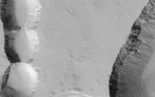<h1>PIA06353:  Pits on Ascraeus</h1><div class="PIA06353" lang="en" style="width:355px;text-align:left;margin:auto;background-color:#000;padding:10px;max-height:150px;overflow:auto;"><p>24 September 2005<br />This Mars Global Surveyor (MGS) Mars Orbiter Camera (MOC) image shows collapse pits and troughs on the lower northeast flank of the giant martian volcano, Ascraeus Mons. Layers of volcanic rock are evident in some of the pit and valley walls, and boulders the size of houses and trucks that were liberated from these walls by gravity can be seen on the floors of the depressions.<p>Location near: 13.6°N, 102.6°W <br />Image width: width: ~3 km (~1.9 mi) <br />Illumination from: lower left <br />Season: Northern Autumn </p><br /><br /><a href="http://photojournal.jpl.nasa.gov/catalog/PIA06353" onclick="window.open(this.href); return false;" title="Voir l'image 	 PIA06353:  Pits on Ascraeus	  sur le site de la NASA">Voir l'image 	 PIA06353:  Pits on Ascraeus	  sur le site de la NASA.</a></div>