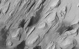 <h1>PIA06798:  Wind Erosion in Aeolis</h1><div class="PIA06798" lang="en" style="width:512px;text-align:left;margin:auto;background-color:#000;padding:10px;max-height:150px;overflow:auto;"><p>09 August 2004<br />This Mars Global Surveyor (MGS) Mars Orbiter Camera (MOC) image shows the effects of severe wind erosion of layered sedimentary rock in the Aeolis region of Mars. The sharp ridges formed by wind movement from the lower left (southwest) toward top/upper right (northeast) are known as yardangs. The dark patches in the lower half of the image are sand dunes. This scene is located near 5.0°S, 203.7°W, and covers an area about 3 km (1.9 mi) across. Sunlight illuminates the terrain from the left/upper left.</p><br /><br /><a href="http://photojournal.jpl.nasa.gov/catalog/PIA06798" onclick="window.open(this.href); return false;" title="Voir l'image 	 PIA06798:  Wind Erosion in Aeolis	  sur le site de la NASA">Voir l'image 	 PIA06798:  Wind Erosion in Aeolis	  sur le site de la NASA.</a></div>