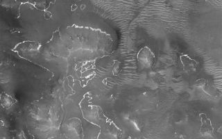 <h1>PIA06800:  Bright Layer Outcrops</h1><div class="PIA06800" lang="en" style="width:800px;text-align:left;margin:auto;background-color:#000;padding:10px;max-height:150px;overflow:auto;"><p>12 August 2004<br />This Mars Global Surveyor (MGS) Mars Orbiter Camera (MOC) image shows outcroppings of a light-toned rock layer on the lower slopes of buttes, hills, and massifs within one of the depressions of the Labyrinthus Noctis (Labyrinth of Night) system of the western Valles Marineris. The layer was once continuous across the area. The image is located near 7.5°S, 96.1°W, and covers an area about 3 km (1.9 mi) across. The scene is illuminated by sunlight from the upper left.</p><br /><br /><a href="http://photojournal.jpl.nasa.gov/catalog/PIA06800" onclick="window.open(this.href); return false;" title="Voir l'image 	 PIA06800:  Bright Layer Outcrops	  sur le site de la NASA">Voir l'image 	 PIA06800:  Bright Layer Outcrops	  sur le site de la NASA.</a></div>