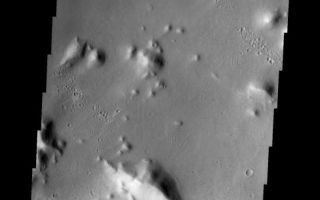 <h1>PIA06821:  The Naming of Things: Tartarus Montes</h1><div class="PIA06821" lang="en" style="width:549px;text-align:left;margin:auto;background-color:#000;padding:10px;max-height:150px;overflow:auto;"><a href="/figures/PIA06821_fig1.jpg"> </a><br /><p>Released August 12, 2004</br>On Earth, landforms like rivers and mountains are given names. The names identify a specfic location and also tell the type of landform; for example: Mount Everest, the Amazon River, the Pacific Ocean. Landforms on other planets and large moons of our solar system are also given names that denote the type of feature and the individual location. It is much easier to discuss the largest volcano in our solar system by using its name (Olympus Mons) rather than its map coordinates (Mars, 32N latitude, 135W longitude).</p><p>There are strict rules and conventions for assigning landform names to solar system bodies. The International Astronomical Union (IAU) is in charge of approving or disapproving submitted names. The online directory of all (non-Earth) planetary names is located at <a href="http://planetarynames.wr.usgs.gov/">http://planetarynames.wr.usgs.gov/</a>. The directory contains information on feature descriptors (Mons = mountain) and categories of names for feature types (valleys on Mars are named for the word "mars" in different languages). The list of descriptor terms can be found at <a href="http://planetarynames.wr.usgs.gov/append5.html">http://planetarynames.wr.usgs.gov/append5.html</a>. Mythologies of different cultures are often used in selecting names; names on Mars are primarily from Greek/Roman mythology, while names on Callisto (a large moon of Jupiter) are from Norse mythology.</p><p>As new data is collected for a planetary body, old names may undergo change. Location names like Olympus are retained, although the lat/long location may be shifted. The usual change is in the descriptor type. Better images may show that a different descriptor gives more accurate information about the landform type; for example, what previously looked like a featureless plain (planitia) in higher resolution is shown to be a huge set of lava flows (fluctus). The THEMIS images shown here will illustrate how some Mars names may need to be updated, while others are still very accurate descriptors of the landforms.</p><p>Tartarus Montes</br>Mons/Montes: mountainsTartarus: In Greek myth, the lowest part of Hades. Zeus imprisoned the Titans in Tartarus.</p><p>The small hills and ridges in this VIS image are the montes of the Tartarus region of Mars.</p><p><b>Nomenclature Fact of the Day:</b> Planetary nomenclature is international in scope; names are chosen from countries and cultures from all over the world, and they are evaluated by international groups of experts before they are approved by the IAU.</p><p>Image information: VIS instrument. Latitude 15.4, Longitude 172.7 East (187.3 West). 19 meter/pixel resolution.</p><p>Note: this THEMIS visual image has not been radiometrically nor geometrically calibrated for this preliminary release. An empirical correction has been performed to remove instrumental effects. A linear shift has been applied in the cross-track and down-track direction to approximate spacecraft and planetary motion. Fully calibrated and geometrically projected images will be released through the Planetary Data System in accordance with Project policies at a later time.</p><p>NASA's Jet Propulsion Laboratory manages the 2001 Mars Odyssey mission for NASA's Office of Space Science, Washington, D.C. The Thermal Emission Imaging System (THEMIS) was developed by Arizona State University, Tempe, in collaboration with Raytheon Santa Barbara Remote Sensing. The THEMIS investigation is led by Dr. Philip Christensen at Arizona State University. Lockheed Martin Astronautics, Denver, is the prime contractor for the Odyssey project, and developed and built the orbiter. Mission operations are conducted jointly from Lockheed Martin and from JPL, a division of the California Institute of Technology in Pasadena.</p><br /><br /><a href="http://photojournal.jpl.nasa.gov/catalog/PIA06821" onclick="window.open(this.href); return false;" title="Voir l'image 	 PIA06821:  The Naming of Things: Tartarus Montes	  sur le site de la NASA">Voir l'image 	 PIA06821:  The Naming of Things: Tartarus Montes	  sur le site de la NASA.</a></div>