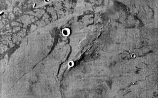 <h1>PIA06824:  Elysium Planitia</h1><div class="PIA06824" lang="en" style="width:465px;text-align:left;margin:auto;background-color:#000;padding:10px;max-height:150px;overflow:auto;"><a href="/figures/PIA06824_fig1.jpg"> </a><br /><p>Released August 17, 2004</br>The THEMIS Image of the Day will be exploring the <a href="/catalog/PIA06821">nomenclature of Mars</a> for the next three weeks.</p><p>Elysium Planitia</br>Planitia: low plainElysium: the Elysian fields. The Elysian fields are a paradise where the chosen of the gods reside after death; the heaven of heroes.</p><p>Elysium Planitia is located south of Elysium Mons, a large volcano. Multiple lava flows are evident in the daytime IR image. There are also small hills and craters of various sizes</p><p><b>Nomenclature Fact of the Day:</b> Names with political, military, or religious significance are not allowed, except for names of political figures prior to the 19th century.</p><p>Image information: IR instrument. Latitude 8.1, Longitude 150.6 East (209.4 West). 100 meter/pixel resolution.</p><p>Note: this THEMIS visual image has not been radiometrically nor geometrically calibrated for this preliminary release. An empirical correction has been performed to remove instrumental effects. A linear shift has been applied in the cross-track and down-track direction to approximate spacecraft and planetary motion. Fully calibrated and geometrically projected images will be released through the Planetary Data System in accordance with Project policies at a later time.</p><p>NASA's Jet Propulsion Laboratory manages the 2001 Mars Odyssey mission for NASA's Office of Space Science, Washington, D.C. The Thermal Emission Imaging System (THEMIS) was developed by Arizona State University, Tempe, in collaboration with Raytheon Santa Barbara Remote Sensing. The THEMIS investigation is led by Dr. Philip Christensen at Arizona State University. Lockheed Martin Astronautics, Denver, is the prime contractor for the Odyssey project, and developed and built the orbiter. Mission operations are conducted jointly from Lockheed Martin and from JPL, a division of the California Institute of Technology in Pasadena.</p><br /><br /><a href="http://photojournal.jpl.nasa.gov/catalog/PIA06824" onclick="window.open(this.href); return false;" title="Voir l'image 	 PIA06824:  Elysium Planitia	  sur le site de la NASA">Voir l'image 	 PIA06824:  Elysium Planitia	  sur le site de la NASA.</a></div>