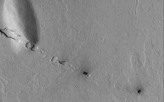 <h1>PIA06857:  Cerberus Fossae Pits</h1><div class="PIA06857" lang="en" style="width:512px;text-align:left;margin:auto;background-color:#000;padding:10px;max-height:150px;overflow:auto;"><p>6 September 2004<br />The Cerberus Fossae are a grouping of narrow troughs formed by extension and cracking of the martian crust in the region southeast of the Elysium volcanoes. This Mars Global Surveyor (MGS) Mars Orbiter Camera (MOC) image shows a small line of collapsed pits that follow the trend of the regional Cerberus Fossae troughs. These aligned pits show the location of a fault line that runs through the plains and cuts the low, rounded hill at the left, center of the image. This area is located near 7.5°N, 191.7°W. The image covers an area approximately 3 km (1.9 mi) across. Sunlight illuminates this scene from the lower left.</p><br /><br /><a href="http://photojournal.jpl.nasa.gov/catalog/PIA06857" onclick="window.open(this.href); return false;" title="Voir l'image 	 PIA06857:  Cerberus Fossae Pits	  sur le site de la NASA">Voir l'image 	 PIA06857:  Cerberus Fossae Pits	  sur le site de la NASA.</a></div>
