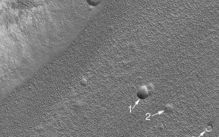 <h1>PIA06900:  Craters in Fretted Terrain</h1><div class="PIA06900" lang="en" style="width:564px;text-align:left;margin:auto;background-color:#000;padding:10px;max-height:150px;overflow:auto;"><p>4 October 2004<br /><a href="http://www.msss.com/others/sharp_memorial/index.html">Robert P. Sharp</a> in a classic Journal of Geophysical Research paper, the fretted terrains of Mars are those in which, at about 200 to 400 meters per pixel scale, have "smooth, flat lowland areas separated from a cratered upland by abrupt escarpments" approximately 1 to 2 km (0.6 to 1.2 mi) high. As viewed from above, the fretted terrain troughs are nearly straight and carve-up old, heavily cratered terrain just north of Arabia Terra and part of northern Tempe Terra. The trough floors in the northern mid-latitude fretted terrain are heavily eroded. These floors were thought, on the basis of Viking orbiter images, to possibly have glaciers or some other form of flowing or creeping ground ice. However, Mars Global Surveyor (MGS) Mars Orbiter Camera (MOC) images have shown little evidence for flow on these pitted and lineated floors. Circular features that were probably once meteor impact craters have not been sheered or deformed, as they would have been if the material were flowing.</p><p>The MOC image shown here exhibits a few examples of the eroded forms of old craters on the floor of a fretted terrain valley. Crater 1 still retains the typical bowl shape of an impact crater, but its raised rims and ejecta blanket have been eroded away. Crater 2 is a shallow depression that might also represent the location of a meteor crater that has nearly eroded away. Feature 3 is a circular mesa; it is probably all that remains of a crater that was filled then eroded away, leaving behind a remnant of the material that filled the crater. Feature 4 is a small depression with a central mound--this, too, may have been an impact crater and the mound is a remnant of material that once filled the crater. In all, erosion appears to have been powerful enough to remove material that once existed above the present landscape, and altered the appearance of craters in this region.</p><p>The image is located near 40.2°N, 335.2°W. The 300 m scale bar is also about 985 ft across. Sunlight illuminates the scene from the lower left. The R. P. Sharp paper described here is, "Mars: Fretted and chaotic terrain," Journal of Geophysical Research,v. 78, n. 20, p. 4073-4083, 1973.</p><br /><br /><a href="http://photojournal.jpl.nasa.gov/catalog/PIA06900" onclick="window.open(this.href); return false;" title="Voir l'image 	 PIA06900:  Craters in Fretted Terrain	  sur le site de la NASA">Voir l'image 	 PIA06900:  Craters in Fretted Terrain	  sur le site de la NASA.</a></div>
