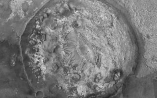 <h1>PIA06912:  Filled and Exhumed Crater</h1><div class="PIA06912" lang="en" style="width:800px;text-align:left;margin:auto;background-color:#000;padding:10px;max-height:150px;overflow:auto;"><p>6 October 2004<br ><p>This picture is a mosaic of three Mars Global Surveyor (MGS) Mars Orbiter Camera (MOC) images (E14-01679, M21-00388, M10-02183) and a lower resolution Mars Odyssey <a href="http://themis.asu.edu">THEMIS VIS</a> image (V09499005), showing details in an exhumed meteor impact crater in eastern Sinus Meridiani. Layered sedimentary rocks are seen within the crater and on the terrain outside the crater. This crater was once completely filled and buried within the martian bedrock. It was most likely encased in rock that is older than the strata being explored by the Mars Exploration Rover (MER-B), Opportunity, several hundred kilometers west of this area. Erosion has brought the old crater back to the surface of Mars. This landform is located near 0.7°N, 352.7°W. The 1 km scale bar is about 0.62 miles long. Sunlight illuminates the images from the left.</p><br /><br /><a href="http://photojournal.jpl.nasa.gov/catalog/PIA06912" onclick="window.open(this.href); return false;" title="Voir l'image 	 PIA06912:  Filled and Exhumed Crater	  sur le site de la NASA">Voir l'image 	 PIA06912:  Filled and Exhumed Crater	  sur le site de la NASA.</a></div>