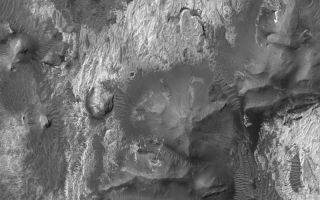 <h1>PIA06942:  Outcrops In Aram Chaos</h1><div class="PIA06942" lang="en" style="width:800px;text-align:left;margin:auto;background-color:#000;padding:10px;max-height:150px;overflow:auto;"><p>16 October 2004<br >Aram Chaos is the name of an approximately 275 km (171 mi) diameter impact crater near Ares Vallis, roughly half way between the Mars Exploration Rover, Opportunity, site in Meridiani Planum and the easternmost troughs of the Valles Marineris. The Aram Chaos crater is partially filled with a thick accumulation of layered rock. Erosion has exposed light- and dark-toned rock materials in the basin. This Mars Global Surveyor (MGS) Mars Orbiter Camera (MOC) image shows a small area exhibiting some of the rock outcrops in Aram Chaos. The light-toned rocks may be sedimentary in origin. This image is located near 4.0°N, 20.6°W, and covers an area about 3 km (1.9 mi) wide. Sunlight illuminates the scene from the upper left.</p><br /><br /><a href="http://photojournal.jpl.nasa.gov/catalog/PIA06942" onclick="window.open(this.href); return false;" title="Voir l'image 	 PIA06942:  Outcrops In Aram Chaos	  sur le site de la NASA">Voir l'image 	 PIA06942:  Outcrops In Aram Chaos	  sur le site de la NASA.</a></div>