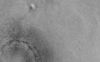 <h1>PIA07125:  Northern Plains "Crater"</h1><div class="PIA07125" lang="en" style="width:800px;text-align:left;margin:auto;background-color:#000;padding:10px;max-height:150px;overflow:auto;"><p>10 December 2004<br >The lower left (southwest) corner of this Mars Global Surveyor (MGS) Mars Orbiter Camera (MOC) image shows the location of a somewhat filled and buried meteor impact crater on the northern plains of Mars. The dark dots are boulders. A portion of a similar feature is seen in the upper right (northeast) corner of the image. This picture, showing landforms (including the odd mound north/northeast of the crater) that are typical of the martian northern lowland plains, was obtained as part of the MGS MOC effort to support the search for a landing site for the Phoenix Mars Scout lander. Phoenix will launch in 2007 and land on the northern plains in 2008. This image is located near 68.0°N, 227.4°W, and covers an area approximately 3 km (1.9 mi) wide. The scene is illuminated by sunlight from the lower left.</p><br /><br /><a href="http://photojournal.jpl.nasa.gov/catalog/PIA07125" onclick="window.open(this.href); return false;" title="Voir l'image 	 PIA07125:  Northern Plains "Crater"	  sur le site de la NASA">Voir l'image 	 PIA07125:  Northern Plains "Crater"	  sur le site de la NASA.</a></div>