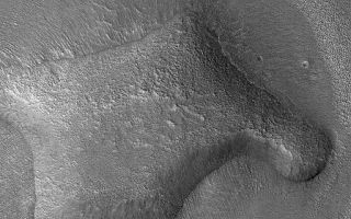 <h1>PIA07153:  Hill In Deuteronilus</h1><div class="PIA07153" lang="en" style="width:512px;text-align:left;margin:auto;background-color:#000;padding:10px;max-height:150px;overflow:auto;"><p>28 December 2004<br >This Mars Global Surveyor (MGS) Mars Orbiter Camera (MOC) image shows an eroded, rounded hill in the Deuteronilus Colles region of Mars, near 40.3°N, 338.8°W. The plains surrounding the hill have been pitted and modified by erosion. Similar pitting is common throughout the middle latitude regions of Mars. Some Mars science investigators have proposed that the pitted materials were ice-rich, and that sublimation of ice has created these textures. However, no similar landforms are found on Earth, thus there is no clear analog that would help scientists better understand the origin of these features. The picture covers an area about 3 km (1.9 mi) wide and is illuminated by sunlight from the left/lower left.</p><br /><br /><a href="http://photojournal.jpl.nasa.gov/catalog/PIA07153" onclick="window.open(this.href); return false;" title="Voir l'image 	 PIA07153:  Hill In Deuteronilus	  sur le site de la NASA">Voir l'image 	 PIA07153:  Hill In Deuteronilus	  sur le site de la NASA.</a></div>