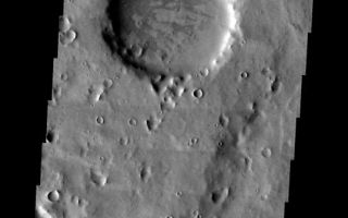 <h1>PIA07173:  Old Crater</h1><div class="PIA07173" lang="en" style="width:536px;text-align:left;margin:auto;background-color:#000;padding:10px;max-height:150px;overflow:auto;"><p><a href="/figures/PIA07173_fig1.jpg"> </a><br /><p>The large crater in the center of this image is older than all the smaller craters in the rest of the VIS image. The crater no longer has any visible rim or ejecta, and is simply a circular smooth floored basin. The interior has been further modified by both impact and the process that formed the darker markings. This image is from the region near Naktong Vallis.</p><p>Image information: VIS instrument. Latitude -1, Longitude 30.7 East (329.3 West). 19 meter/pixel resolution.</p><p>Note: this THEMIS visual image has not been radiometrically nor geometrically calibrated for this preliminary release. An empirical correction has been performed to remove instrumental effects. A linear shift has been applied in the cross-track and down-track direction to approximate spacecraft and planetary motion. Fully calibrated and geometrically projected images will be released through the Planetary Data System in accordance with Project policies at a later time.</p><p>NASA's Jet Propulsion Laboratory manages the 2001 Mars Odyssey mission for NASA's Office of Space Science, Washington, D.C. The Thermal Emission Imaging System (THEMIS) was developed by Arizona State University, Tempe, in collaboration with Raytheon Santa Barbara Remote Sensing. The THEMIS investigation is led by Dr. Philip Christensen at Arizona State University. Lockheed Martin Astronautics, Denver, is the prime contractor for the Odyssey project, and developed and built the orbiter. Mission operations are conducted jointly from Lockheed Martin and from JPL, a division of the California Institute of Technology in Pasadena.</p><br /><br /><a href="http://photojournal.jpl.nasa.gov/catalog/PIA07173" onclick="window.open(this.href); return false;" title="Voir l'image 	 PIA07173:  Old Crater	  sur le site de la NASA">Voir l'image 	 PIA07173:  Old Crater	  sur le site de la NASA.</a></div>