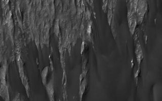 <h1>PIA07279:  Ganges Rocks and Sand</h1><div class="PIA07279" lang="en" style="width:552px;text-align:left;margin:auto;background-color:#000;padding:10px;max-height:150px;overflow:auto;"><p>17 January 2004<br >The top half of this Mars Global Surveyor (MGS) Mars Orbiter Camera (MOC) image shows wind-eroded remnants of sedimentary rock outcrops in Ganges Chasma, one of the troughs of the Valles Marineris system. The lower half shows a thick accumulation of dark, windblown sand. The image covers an area about 3 km (1.9 mi) wide and is illuminated by sunlight from the upper left. These features are located near 7.6°S, 49.4°W.</p><br /><br /><a href="http://photojournal.jpl.nasa.gov/catalog/PIA07279" onclick="window.open(this.href); return false;" title="Voir l'image 	 PIA07279:  Ganges Rocks and Sand	  sur le site de la NASA">Voir l'image 	 PIA07279:  Ganges Rocks and Sand	  sur le site de la NASA.</a></div>