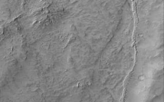 <h1>PIA07376:  Inverted Channel</h1><div class="PIA07376" lang="en" style="width:328px;text-align:left;margin:auto;background-color:#000;padding:10px;max-height:150px;overflow:auto;"><p>This Mars Global Surveyor (MGS) Orbiter Camera (MOC) image shows an inverted channel running down, through a valley in the Memnonia Sulci region of Mars. The original channel is gone, as are the rocks through which it cut. The channel floor and/or the material that filled the channel was more resistant to erosion, and thus left standing high as a ridge. Inverted channels and valleys are common on Mars. Many old valley networks have been filled, buried, and in some cases, exhumed and inverted, all across the planet.</p><p>Location near: 11.4°S, 174.4°W <br />Image width: ~3.0 km (~1.9 mi) <br />Illumination from: upper left <br />Season: Southern Winter <br /></p><br /><br /><a href="http://photojournal.jpl.nasa.gov/catalog/PIA07376" onclick="window.open(this.href); return false;" title="Voir l'image 	 PIA07376:  Inverted Channel	  sur le site de la NASA">Voir l'image 	 PIA07376:  Inverted Channel	  sur le site de la NASA.</a></div>