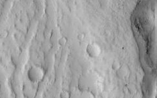 <h1>PIA07384:  Hecates Tholus Channels</h1><div class="PIA07384" lang="en" style="width:243px;text-align:left;margin:auto;background-color:#000;padding:10px;max-height:150px;overflow:auto;"><p>24 February 2005 <br />This Mars Global Surveyor (MGS) Orbiter Camera (MOC) image shows narrow channels and small impact craters on the north flank of the Elysium volcano, Hecates Tholus.</p><p>Location near: 34.0°N, 210.3°W <br />Image width: ~1 km (~0.6 mi) <br />Illumination from: upper left <br />Season: Southern Winter <br /></p><br /><br /><a href="http://photojournal.jpl.nasa.gov/catalog/PIA07384" onclick="window.open(this.href); return false;" title="Voir l'image 	 PIA07384:  Hecates Tholus Channels	  sur le site de la NASA">Voir l'image 	 PIA07384:  Hecates Tholus Channels	  sur le site de la NASA.</a></div>