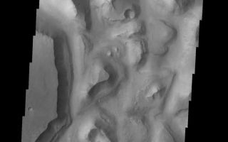 <h1>PIA07484:  Eos Chasma Mensa</h1><div class="PIA07484" lang="en" style="width:577px;text-align:left;margin:auto;background-color:#000;padding:10px;max-height:150px;overflow:auto;"><a href="/figures/PIA07484_fig1.jpg"></a><br /><p>The topic for the Image of the Day for the weeks of March 7-18 will be mountains on Mars.</p><p>This image is located in Eos Chasma and contains a a feature type called a Mensa, from the Latin word for 'table.' A Mensa is a flat-topped prominence with cliff-like edges.</p><p>A good diagram showing the structural difference between simple and complex craters is here: <a href="http://www.lpi.usra.edu/expmoon/science/craterstructure.html">http://www.lpi.usra.edu/expmoon/science/craterstructure.html</a></p>Image information: VIS instrument. Latitude 0.4, Longitude 324.5 East (35.5 West). 19 meter/pixel resolution.</p><p>Note: this THEMIS visual image has not been radiometrically nor geometrically calibrated for this preliminary release. An empirical correction has been performed to remove instrumental effects. A linear shift has been applied in the cross-track and down-track direction to approximate spacecraft and planetary motion. Fully calibrated and geometrically projected images will be released through the Planetary Data System in accordance with Project policies at a later time.</p><p>NASA's Jet Propulsion Laboratory manages the 2001 Mars Odyssey mission for NASA's Office of Space Science, Washington, D.C. The Thermal Emission Imaging System (THEMIS) was developed by Arizona State University, Tempe, in collaboration with Raytheon Santa Barbara Remote Sensing. The THEMIS investigation is led by Dr. Philip Christensen at Arizona State University. Lockheed Martin Astronautics, Denver, is the prime contractor for the Odyssey project, and developed and built the orbiter. Mission operations are conducted jointly from Lockheed Martin and from JPL, a division of the California Institute of Technology in Pasadena.</p><br /><br /><a href="http://photojournal.jpl.nasa.gov/catalog/PIA07484" onclick="window.open(this.href); return false;" title="Voir l'image 	 PIA07484:  Eos Chasma Mensa	  sur le site de la NASA">Voir l'image 	 PIA07484:  Eos Chasma Mensa	  sur le site de la NASA.</a></div>
