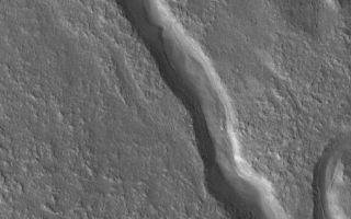 <h1>PIA07843:  Valley Near Moreux</h1><div class="PIA07843" lang="en" style="width:796px;text-align:left;margin:auto;background-color:#000;padding:10px;max-height:150px;overflow:auto;"><p>17 April 2005 <br />This Mars Global Surveyor (MGS) Mars Orbiter Camera (MOC) image shows a valley located at north middle-latitudes near Moreux Crater. This valley might once have been the conduit for a flowing liquid, such as water. Today, the valley is partially filled and the surrounding terrain has the characteristic "roughened" appearance common at middle latitudes in both martian hemispheres.</p><p>Location near: 40.7°N, 316.4°W <br />Image width: ~3 km (~1.9 mi) <br />Illumination from: lower left <br />Season: Northern Summer <br /></p><br /><br /><a href="http://photojournal.jpl.nasa.gov/catalog/PIA07843" onclick="window.open(this.href); return false;" title="Voir l'image 	 PIA07843:  Valley Near Moreux	  sur le site de la NASA">Voir l'image 	 PIA07843:  Valley Near Moreux	  sur le site de la NASA.</a></div>