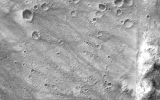 <h1>PIA07849:  Plains and Hills Explored by Spirit</h1><div class="PIA07849" lang="en" style="width:800px;text-align:left;margin:auto;background-color:#000;padding:10px;max-height:150px;overflow:auto;"><p><a href="/figures/PIA07849_fig1.jpg"></a><br>Figure 1: Spirit's Long Journey, Sol 450</p><p>This view from orbit shows the region within Gusev Crater where NASA's Mars Exploration Rover Spirit has been working for the past 15 months. The view is a mosaic of images from the Mars Orbiter Camera on NASA's Mars Global Surveyor orbiter. In the left and central portion, previously released as PIA07192, tracks made by Spirit's wheels are visible from the landing site to the edge of the "Columbia Hills."</p><p><b>Spirit's Long Journey, Sol 450 (Full Traverse)</b> <br >More than 15 months after landing on Mars, NASA's Spirit rover is still going strong, having traveled a total of 4,276 meters (2.66 miles) as of martian day, or sol, 450 (April 8, 2005). This elevation map shows the traverse followed by Spirit since arriving at the "Columbia Hills" in June, 2004. The areas colored blue are low in elevation and areas colored yellow are high in elevation. The blue area at the foot of the "Columbia Hills" is approximately 20 meters (66 feet) higher in elevation than the site where Spirit landed in Gusev Crater. The highest peak is on the order of 80 meters (262 feet) higher still. In other words, the hills Spirit is exploring are more than 250 feet high. The map imagery is from the Mars Orbiter Camera on NASA's Mars Global Surveyor.</p><br /><br /><a href="http://photojournal.jpl.nasa.gov/catalog/PIA07849" onclick="window.open(this.href); return false;" title="Voir l'image 	 PIA07849:  Plains and Hills Explored by Spirit	  sur le site de la NASA">Voir l'image 	 PIA07849:  Plains and Hills Explored by Spirit	  sur le site de la NASA.</a></div>