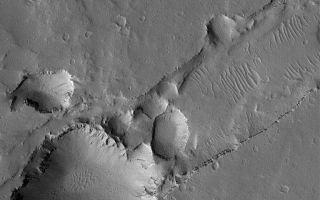 <h1>PIA07884:  Collapse Pits</h1><div class="PIA07884" lang="en" style="width:512px;text-align:left;margin:auto;background-color:#000;padding:10px;max-height:150px;overflow:auto;"><p>24 April 2005<br />This Mars Global Surveyor (MGS) Mars Orbiter Camera (MOC) image shows a large and several small pits formed by collapse along the trend of a fault system in the Uranius Fossae region of Mars. Running diagonal from middle-right toward lower left is a trough that intersects the pit. The trough is a typical graben formed by faulting as the upper crust of Mars split and pulled apart at this location. The opening of the graben also led to formation of the collapse pits.</p><p>Location near: 26.2°N, 88.7°W <br />Image width: ~3 km (~1.9 mi) <br />Illumination from: lower left <br />Season: Northern Summer <br /></p><br /><br /><a href="http://photojournal.jpl.nasa.gov/catalog/PIA07884" onclick="window.open(this.href); return false;" title="Voir l'image 	 PIA07884:  Collapse Pits	  sur le site de la NASA">Voir l'image 	 PIA07884:  Collapse Pits	  sur le site de la NASA.</a></div>