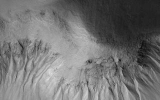 <h1>PIA07959:  Gullied Slope</h1><div class="PIA07959" lang="en" style="width:800px;text-align:left;margin:auto;background-color:#000;padding:10px;max-height:150px;overflow:auto;"><p>20 May 2005<br />This Mars Global Surveyor (MGS) Mars Orbiter Camera (MOC) image shows gullies formed on an equator-facing slope among mounds in Acidalia Planitia. Similar gullies occur in a variety of settings at middle and polar latitudes in both martian hemispheres.</p><p>Location near: 49.8°N, 22.7°W<br />Image width: ~3 km (~1.9 mi) <br />Illumination from: lower left <br />Season: Northern Summer <br /></p><br /><br /><a href="http://photojournal.jpl.nasa.gov/catalog/PIA07959" onclick="window.open(this.href); return false;" title="Voir l'image 	 PIA07959:  Gullied Slope	  sur le site de la NASA">Voir l'image 	 PIA07959:  Gullied Slope	  sur le site de la NASA.</a></div>