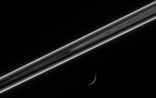 <h1>PIA08201:  Saturn's Night Lights</h1><div class="PIA08201" lang="en" style="width:800px;text-align:left;margin:auto;background-color:#000;padding:10px;max-height:150px;overflow:auto;"><p>The dark side of the ringplane glows with scattered light, including the luminous F ring, which shines like a rope of brilliant neon. Below, Dione (1,126 kilometers, or 700 miles across) presents an exquisitely thin crescent.</p><p>The image was taken using a spectral filter sensitive to wavelengths of infrared light centered at 930 nanometers. The image was acquired with the Cassini spacecraft narrow-angle camera on May 3, 2006 at a distance of approximately 1.8 million kilometers (1.1 million miles) from Dione and at a Sun-Dione-spacecraft, or phase, angle of 160 degrees. Image scale is 11 kilometers (7 miles) per pixel.</p><p>The Cassini-Huygens mission is a cooperative project of NASA, the European Space Agency and the Italian Space Agency. The Jet Propulsion Laboratory, a division of the California Institute of Technology in Pasadena, manages the mission for NASA's Science Mission Directorate, Washington, D.C. The Cassini orbiter and its two onboard cameras were designed, developed and assembled at JPL. The imaging operations center is based at the Space Science Institute in Boulder, Colo.</p><p>For more information about the Cassini-Huygens mission visit <a href="http://saturn.jpl.nasa.gov">http://saturn.jpl.nasa.gov/home/index.cfm</a>. The Cassini imaging team homepage is at <a href="http://ciclops.org">http://ciclops.org</a>.</p><br /><br /><a href="http://photojournal.jpl.nasa.gov/catalog/PIA08201" onclick="window.open(this.href); return false;" title="Voir l'image 	 PIA08201:  Saturn's Night Lights	  sur le site de la NASA">Voir l'image 	 PIA08201:  Saturn's Night Lights	  sur le site de la NASA.</a></div>
