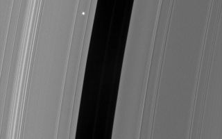 <h1>PIA08283:  Flickering Aldebaran #1</h1><div class="PIA08283" lang="en" style="width:800px;text-align:left;margin:auto;background-color:#000;padding:10px;max-height:150px;overflow:auto;"><p>The Cassini spacecraft took a series of images on Sept. 9, 2006 as it watched the bright red giant star Aldebaran slip behind Saturn's rings. This type of observation is known as a stellar occultation and uses a star whose brightness is well known. As Cassini watches the rings pass in front of the star, the star's light fluctuates, providing information about the concentrations of ring particles within the various radial features in the rings.</p><p>This view shows the Encke Gap (325 kilometers, or 200 miles wide) and the faint ringlets which share the gap with the embedded moon Pan. The view looks toward the sunlit side of the rings from about 19 degrees below the ringplane. Bright Aldebaran is overexposed, creating thin vertical lines on its image.</p><p>The image was taken in visible light with the Cassini spacecraft narrow-angle camera on Sept. 9, 2006 at a distance of approximately 359,000 kilometers (233,000 miles) from Saturn. Image scale on the sky at the distance of Saturn is 2 kilometers (1 mile) per pixel.</p><p>The Cassini-Huygens mission is a cooperative project of NASA, the European Space Agency and the Italian Space Agency. The Jet Propulsion Laboratory, a division of the California Institute of Technology in Pasadena, manages the mission for NASA's Science Mission Directorate, Washington, D.C. The Cassini orbiter and its two onboard cameras were designed, developed and assembled at JPL. The imaging operations center is based at the Space Science Institute in Boulder, Colo.</p><p>For more information about the Cassini-Huygens mission visit <a href="http://saturn.jpl.nasa.gov">http://saturn.jpl.nasa.gov/home/index.cfm</a>. The Cassini imaging team homepage is at <a href="http://ciclops.org">http://ciclops.org</a>.</p><br /><br /><a href="http://photojournal.jpl.nasa.gov/catalog/PIA08283" onclick="window.open(this.href); return false;" title="Voir l'image 	 PIA08283:  Flickering Aldebaran #1	  sur le site de la NASA">Voir l'image 	 PIA08283:  Flickering Aldebaran #1	  sur le site de la NASA.</a></div>