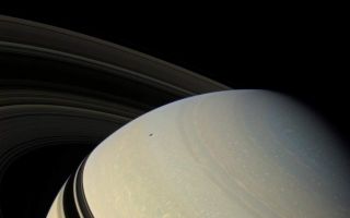 <h1>PIA08414:  Perspective on Saturn</h1><div class="PIA08414" lang="en" style="width:800px;text-align:left;margin:auto;background-color:#000;padding:10px;max-height:150px;overflow:auto;"><p>The ringed planet sits in repose, the center of its own macrocosm of many rings and moons and one artificial satellite named Cassini. Mimas (397 kilometers, or 247 miles across) is visible at upper left. Although unseen in this view, Enceladus (504 kilometers, or 313 miles across) casts its shadow upon the planet. The rings also block the sun's light from the low latitudes of the northern hemisphere. </p><p>During Cassini's extended mission, dubbed the Cassini Equinox Mission, which begins on July 1, 2008, the ring shadows will slip past the planet's equator and into the southern hemisphere as Saturn passes through its northern vernal equinox on August 11, 2009, and the sun moves northward through the ring plane.</p><p>This view looks down on the un-illuminated side of the rings from about 22 degrees above (north of) the ring plane. Images taken using red, green and blue spectral filters were combined to create this natural color view. The images were obtained with the Cassini spacecraft wide-angle camera on Dec. 16, 2007, at a distance of approximately 1.4 million kilometers (900,000 miles) from Saturn. Image scale is 86 kilometers (53 miles) per pixel.</p><p>The Cassini-Huygens mission is a cooperative project of NASA, the European Space Agency and the Italian Space Agency. The Jet Propulsion Laboratory, a division of the California Institute of Technology in Pasadena, manages the mission for NASA's Science Mission Directorate, Washington, D.C. The Cassini orbiter and its two onboard cameras were designed, developed and assembled at JPL. The imaging operations center is based at the Space Science Institute in Boulder, Colo.</p><p>For more information about the Cassini-Huygens mission visit <a href="http://saturn.jpl.nasa.gov" class="external free" target="wpext">http://saturn.jpl.nasa.gov/</a>. The Cassini imaging team homepage is at <a href="http://ciclops.org" class="external free" target="wpext">http://ciclops.org</a>.<br /><br /><a href="http://photojournal.jpl.nasa.gov/catalog/PIA08414" onclick="window.open(this.href); return false;" title="Voir l'image 	 PIA08414:  Perspective on Saturn	  sur le site de la NASA">Voir l'image 	 PIA08414:  Perspective on Saturn	  sur le site de la NASA.</a></div>