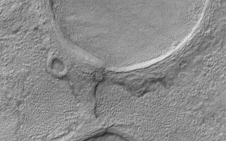 <h1>PIA08548:  Martian Spectacles</h1><div class="PIA08548" lang="en" style="width:630px;text-align:left;margin:auto;background-color:#000;padding:10px;max-height:150px;overflow:auto;"><p>19 June 2006<br />This Mars Global Surveyor (MGS) Mars Orbiter Camera (MOC) image shows a pair of partially-buried impact craters which are being exhumed on a plain east of Hellas in the Promethei Terra region Mars.</p><p>Location near: 45.5°S, 256.5°W <br />Image width: ~3 km (~1.9 mi) <br />Illumination from: upper left <br /> Season: Southern Autumn </p><br /><br /><a href="http://photojournal.jpl.nasa.gov/catalog/PIA08548" onclick="window.open(this.href); return false;" title="Voir l'image 	 PIA08548:  Martian Spectacles	  sur le site de la NASA">Voir l'image 	 PIA08548:  Martian Spectacles	  sur le site de la NASA.</a></div>