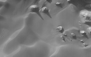 <h1>PIA08569:  Rabe Landforms</h1><div class="PIA08569" lang="en" style="width:800px;text-align:left;margin:auto;background-color:#000;padding:10px;max-height:150px;overflow:auto;"><p>29 June 2006<br />This Mars Global Surveyor (MGS) Mars Orbiter Camera (MOC) image shows buttes and mesas surrounded by sand dunes on the floor of Rabe Crater, Mars. Gullies of uncertain origin cut sand dune surfaces in the top (north) quarter of the scene.</p><p>Location near: 44.1°S, 325.8°W <br />Image width: ~3 km (~1.9 mi) <br />Illumination from: upper left <br />Season: Southern Winter </p><br /><br /><a href="http://photojournal.jpl.nasa.gov/catalog/PIA08569" onclick="window.open(this.href); return false;" title="Voir l'image 	 PIA08569:  Rabe Landforms	  sur le site de la NASA">Voir l'image 	 PIA08569:  Rabe Landforms	  sur le site de la NASA.</a></div>