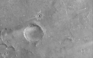 <h1>PIA08601:  Syrtis Plain</h1><div class="PIA08601" lang="en" style="width:672px;text-align:left;margin:auto;background-color:#000;padding:10px;max-height:150px;overflow:auto;"><p>12 July 2006<br />This Mars Global Surveyor (MGS) Mars Orbiter Camera (MOC) image shows terrain southwest of Meroe Patera in Syrtis Major Planum, Mars. Wind streaks formed in the lee -- i.e., the downwind side -- of impact craters are common throughout the scene, including the small impact crater near the center of the image with light-toned ejecta radiating outward from its rim. Near the bottom (south) of the image, three light-toned slope streaks, created by dry mass movements of dust, extend down the sloping side walls of two overlapping impact craters.</p><p>Location near: 5.3°N, 295.4°W <br />Image width: ~3 km (~1.9 mi) <br />Illumination from: lower left <br />Season: Northern Winter </p><br /><br /><a href="http://photojournal.jpl.nasa.gov/catalog/PIA08601" onclick="window.open(this.href); return false;" title="Voir l'image 	 PIA08601:  Syrtis Plain	  sur le site de la NASA">Voir l'image 	 PIA08601:  Syrtis Plain	  sur le site de la NASA.</a></div>