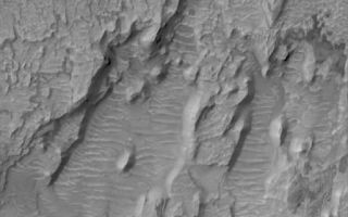 <h1>PIA08602:  Scalloped Floor</h1><div class="PIA08602" lang="en" style="width:446px;text-align:left;margin:auto;background-color:#000;padding:10px;max-height:150px;overflow:auto;"><p>13 July 2006<br />This Mars Global Surveyor (MGS) Mars Orbiter Camera (MOC) image shows erosional remnants of layered rock and large windblown ripples on the floor of a crater in the Tyrrhena Terra region of Mars. The layered rocks are most likely sedimentary.</p><p>Location near: 15.5°S, 270.5°W <br />Image width: ~3 km (~1.9 mi) <br />Illumination from: upper left <br />Season: Southern Autumn </p><br /><br /><a href="http://photojournal.jpl.nasa.gov/catalog/PIA08602" onclick="window.open(this.href); return false;" title="Voir l'image 	 PIA08602:  Scalloped Floor	  sur le site de la NASA">Voir l'image 	 PIA08602:  Scalloped Floor	  sur le site de la NASA.</a></div>