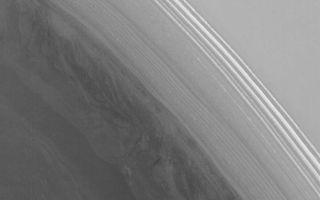 <h1>PIA08648:  Striped Scarp</h1><div class="PIA08648" lang="en" style="width:762px;text-align:left;margin:auto;background-color:#000;padding:10px;max-height:150px;overflow:auto;"><p>28 July 2006<br />This Mars Global Surveyor (MGS) Mars Orbiter Camera (MOC) image shows a steep slope in the north polar region of Mars. The stripes indicate an exposure of layered material; the variations in brightness among the stripes are the result of varying amounts and textures on seasonal carbon dioxide frost. At the time the image was acquired in June 2006, the carbon dioxide frost was beginning to sublime way, leaving a variety of different patterns in frost distribution.<p>Location near: 85.2°N, 122.7°W <br />Image width: ~3 km (~1.9 mi) <br />Illumination from: lower left <br />Season: Northern Spring </p><br /><br /><a href="http://photojournal.jpl.nasa.gov/catalog/PIA08648" onclick="window.open(this.href); return false;" title="Voir l'image 	 PIA08648:  Striped Scarp	  sur le site de la NASA">Voir l'image 	 PIA08648:  Striped Scarp	  sur le site de la NASA.</a></div>