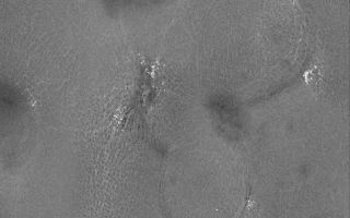 <h1>PIA08765:  Buried Craters</h1><div class="PIA08765" lang="en" style="width:643px;text-align:left;margin:auto;background-color:#000;padding:10px;max-height:150px;overflow:auto;"><p>17 September 2006<br />This Mars Global Surveyor (MGS) Mars Orbiter Camera (MOC) image shows rugged terrain in the northern plains. The circular features are old, buried impact craters. The bright spots are small patches of the seasonal frost that has been almost entirely removed from the area by sublimation (turning from solid to gas).</p><p>Location near: 70.7°N, 271.0°W <br />Image width: ~3 km (~1.9 mi) <br />Illumination from: lower left <br />Season: Northern Spring </p><br /><br /><a href="http://photojournal.jpl.nasa.gov/catalog/PIA08765" onclick="window.open(this.href); return false;" title="Voir l'image 	 PIA08765:  Buried Craters	  sur le site de la NASA">Voir l'image 	 PIA08765:  Buried Craters	  sur le site de la NASA.</a></div>