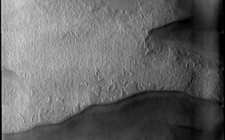 <h1>PIA09165:  South Polar Spring</h1><div class="PIA09165" lang="en" style="width:404px;text-align:left;margin:auto;background-color:#000;padding:10px;max-height:150px;overflow:auto;"><p><a href="/figures/PIA09165_fig1.jpg"></a><br><b>Context image for PIA09165<br />South Polar Spring</b></p><p>This image of the south polar cap was collected at the start of southern spring. The low sun angle highlights the different surface textures.<p>Image information: VIS instrument. Latitude -86.8N, Longitude 276.4E. 17 meter/pixel resolution.</p><p>Please see the <a href="http://themis.asu.edu/terms" target="_blank">THEMIS Data Citation Note</a> for details on crediting THEMIS images.</p><p>Note: this THEMIS visual image has not been radiometrically nor geometrically calibrated for this preliminary release. An empirical correction has been performed to remove instrumental effects. A linear shift has been applied in the cross-track and down-track direction to approximate spacecraft and planetary motion. Fully calibrated and geometrically projected images will be released through the Planetary Data System in accordance with Project policies at a later time.</p><p>NASA's Jet Propulsion Laboratory manages the 2001 Mars Odyssey mission for NASA's Office of Space Science, Washington, D.C. The Thermal Emission Imaging System (THEMIS) was developed by Arizona State University, Tempe, in collaboration with Raytheon Santa Barbara Remote Sensing. The THEMIS investigation is led by Dr. Philip Christensen at Arizona State University. Lockheed Martin Astronautics, Denver, is the prime contractor for the Odyssey project, and developed and built the orbiter. Mission operations are conducted jointly from Lockheed Martin and from JPL, a division of the California Institute of Technology in Pasadena.</p><br /><br /><a href="http://photojournal.jpl.nasa.gov/catalog/PIA09165" onclick="window.open(this.href); return false;" title="Voir l'image 	 PIA09165:  South Polar Spring	  sur le site de la NASA">Voir l'image 	 PIA09165:  South Polar Spring	  sur le site de la NASA.</a></div>